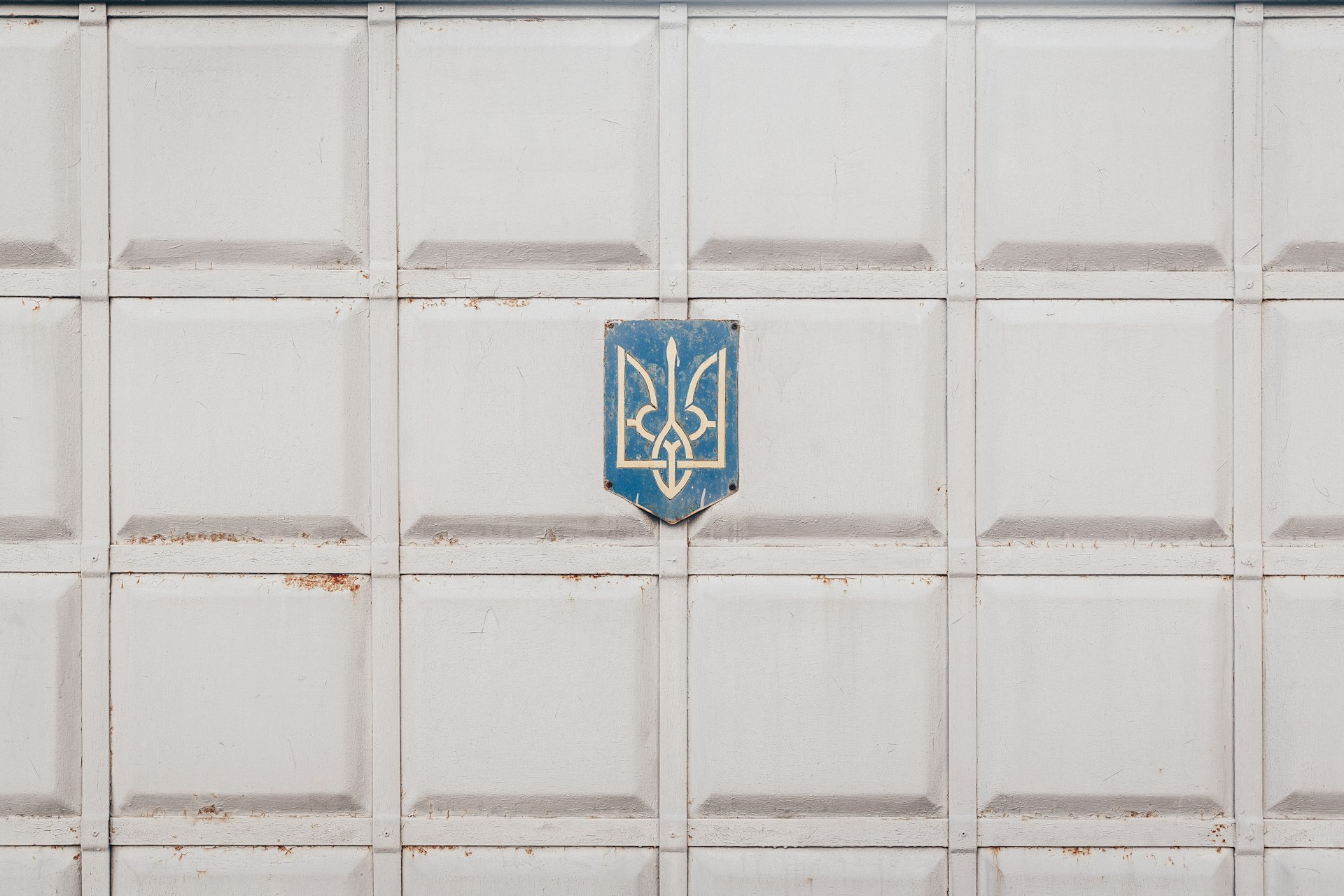 blue and white emblem on white wall